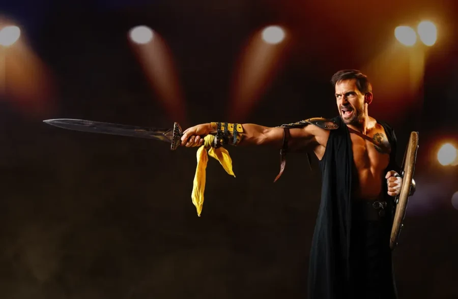 A gladiator pointing his sword under the arena lights